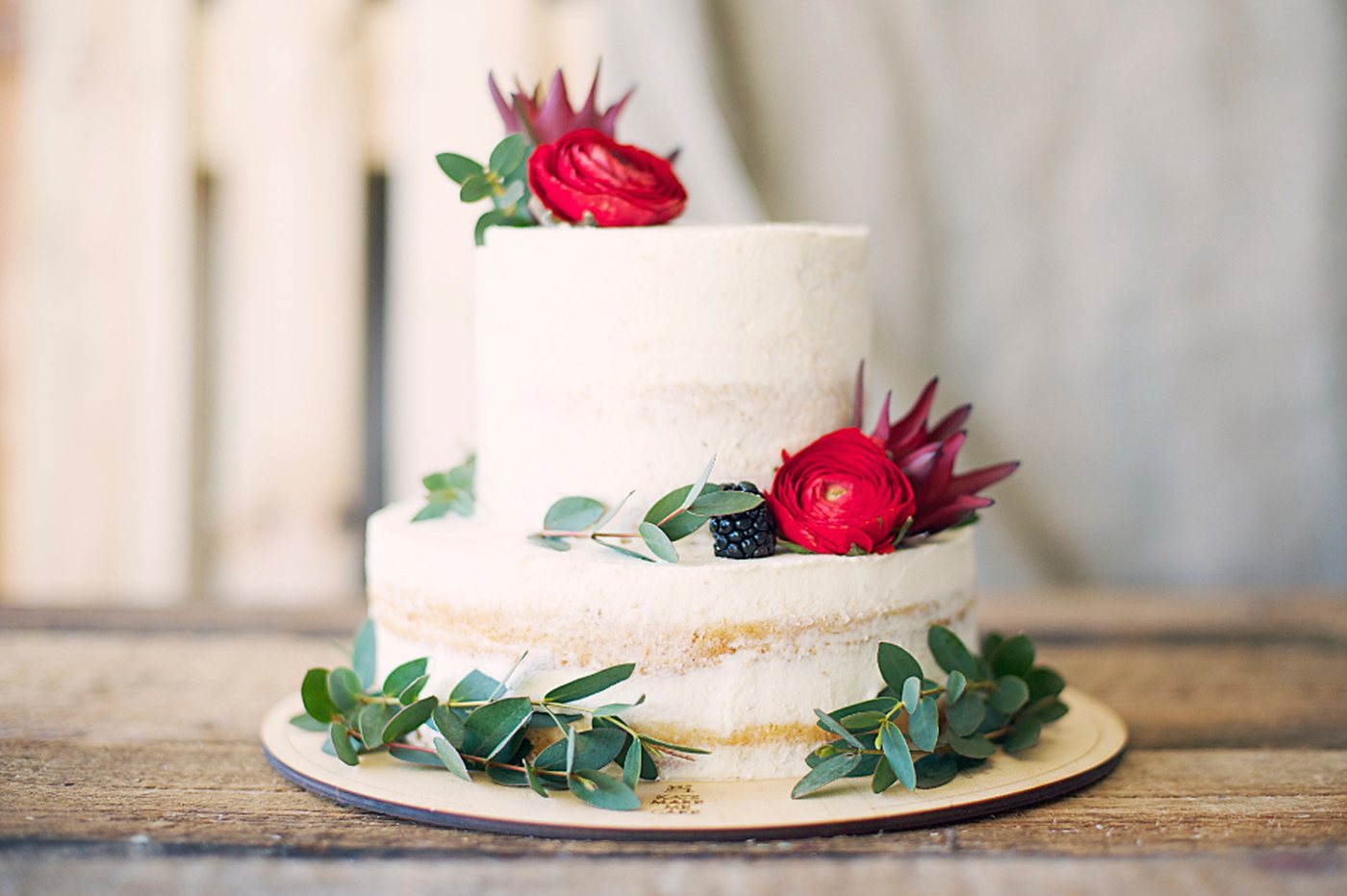 A two-tier cake finished with fresh flowers